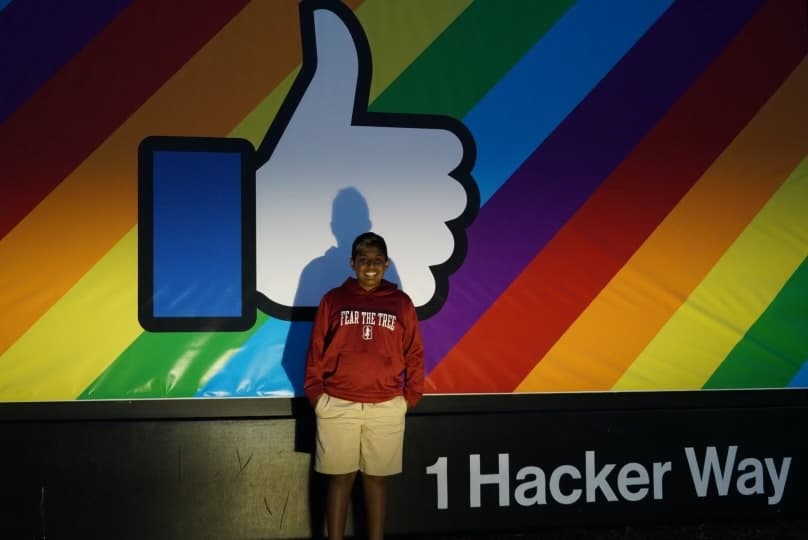 Me standing in front of Facebook's sign on 1 Hacker Way